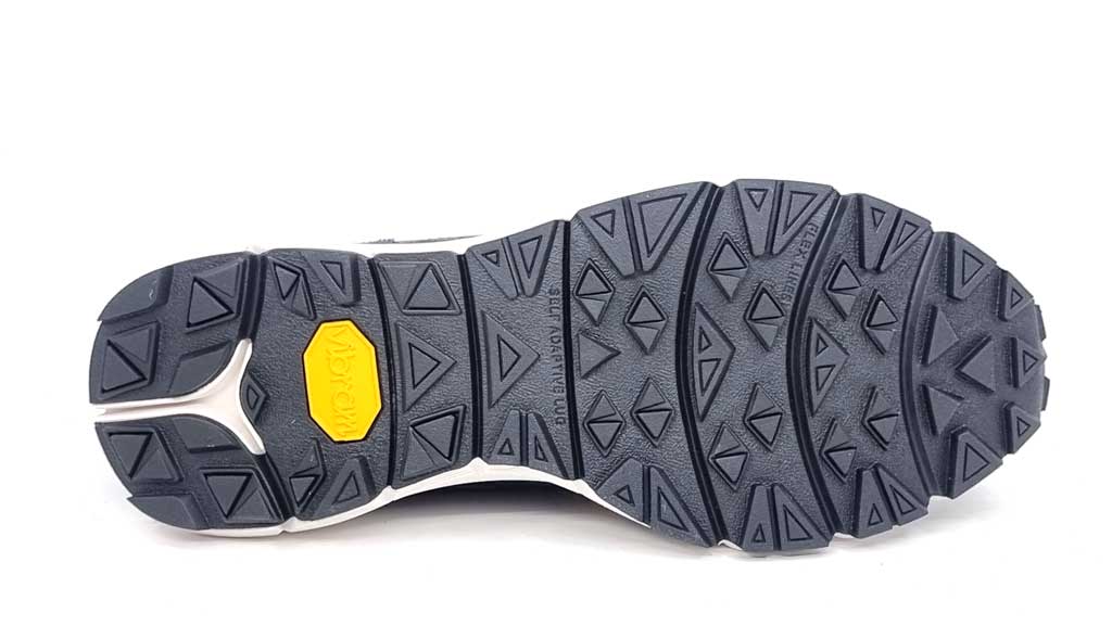 A detailed close-up of the sneaker’s durable Vibram rubber sole. The textured tread pattern is designed for maximum traction and flexibility, ensuring stability on different surfaces. The high-quality rubber material provides long-lasting wear, making these sneakers both stylish and practical. The embossed Vibram logo signifies superior craftsmanship and performance.